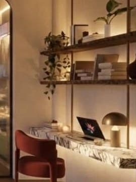 Floating marble desk with a rust chair beneath walnut shelves hung on slim vertical rods.